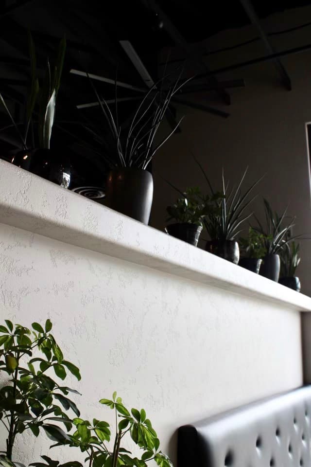 Restaurant interior with white walls and plants